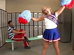 Adorable blonde teen cheerleader talking with her teacher